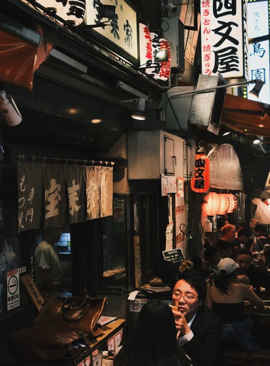 A narrow Tsukiji lane of small eateries under their lanterns and signboards