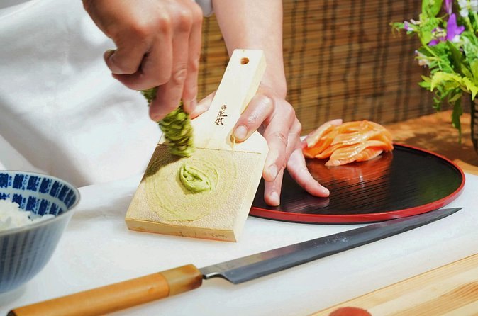 Fresh wasabi grated to order beside a plate of sashimi