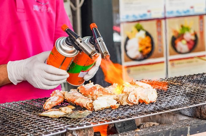 Scallops seared under a blowtorch at a Tsukiji stall counter
