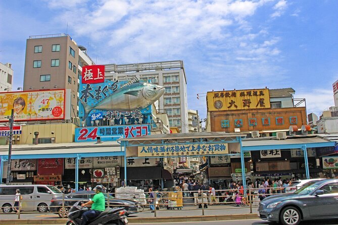 A Tsukiji street of market shopfronts and signage on a bright morning