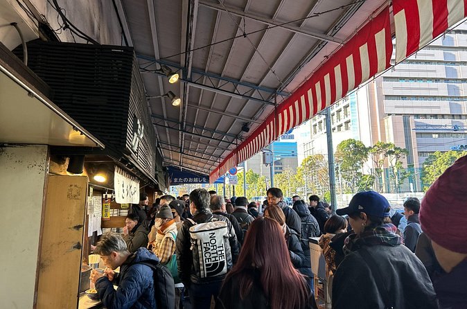 The covered main lane of the Tsukiji Outer Market, busy with shoppers