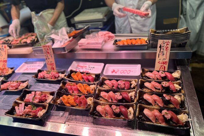 Cuts of tuna and roe priced by the tray at a Tsukiji counter