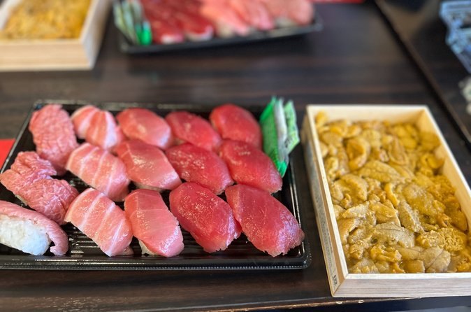 A tray of tuna nigiri and a tray of tamagoyaki on a Tsukiji counter